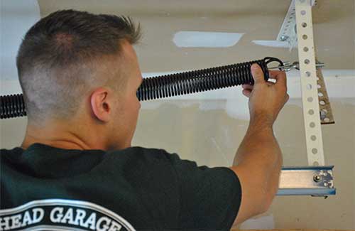 Technician Installing Extension Spring
